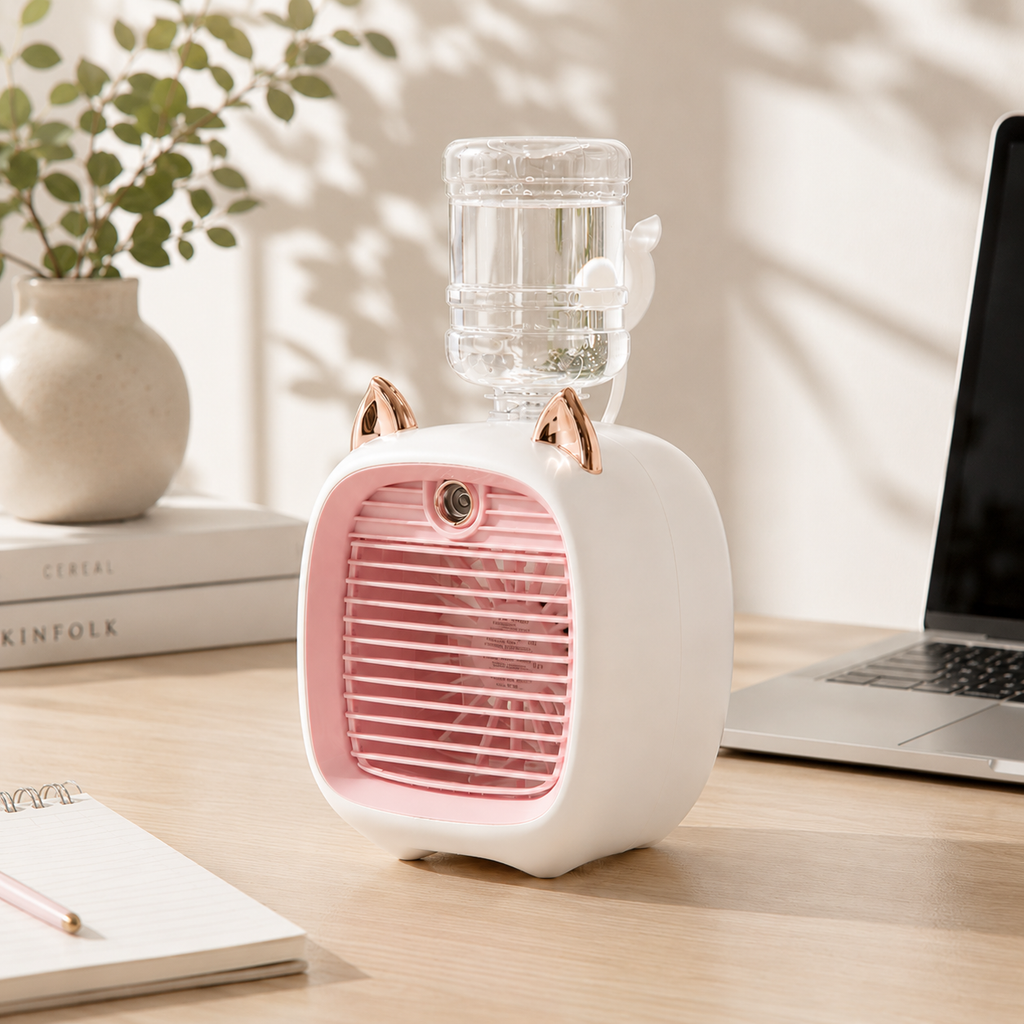 White mini cat mist fan with pink grille, gold ears, and a clear water bottle on a wooden desk.