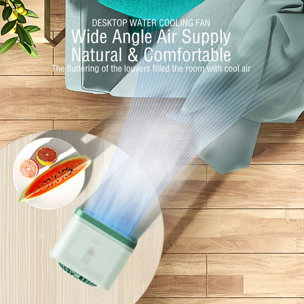 Green and white rechargeable mini air cooler and humidifier on a wooden table, emitting cool air.